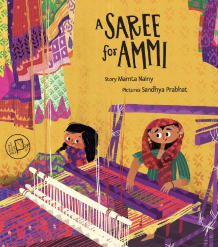 Cover for A Saree for Ammi featuring an illustration of a woman and her child where the woman is making a textile using a loom while her daughter looks on. There are colorful patterned textiles in the background and the cover's background is an orangey brown.