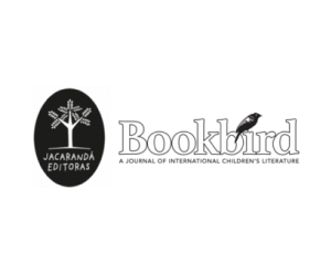 Hero image for Bookbird: A Journal of International Children's Literature featuring the journal's title logo with the word 'Bookbird' in large outlined type with a crow on top of it to the right and a black emblem to the left with a graphic of a tree in white inside of it with the text "Jacarandá Editoras".