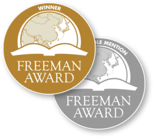 Hero image for Freeman Awards depicting two seals overlapping each other. The seal on top is gold with the text "winner" on top and the seal on the bottom is silver with the text "honorable mention" on top. Each has the logo for the award with the text "Freeman Award" in all uppercase letter below a graphic of an open book with a semi-circle map of the world above it.