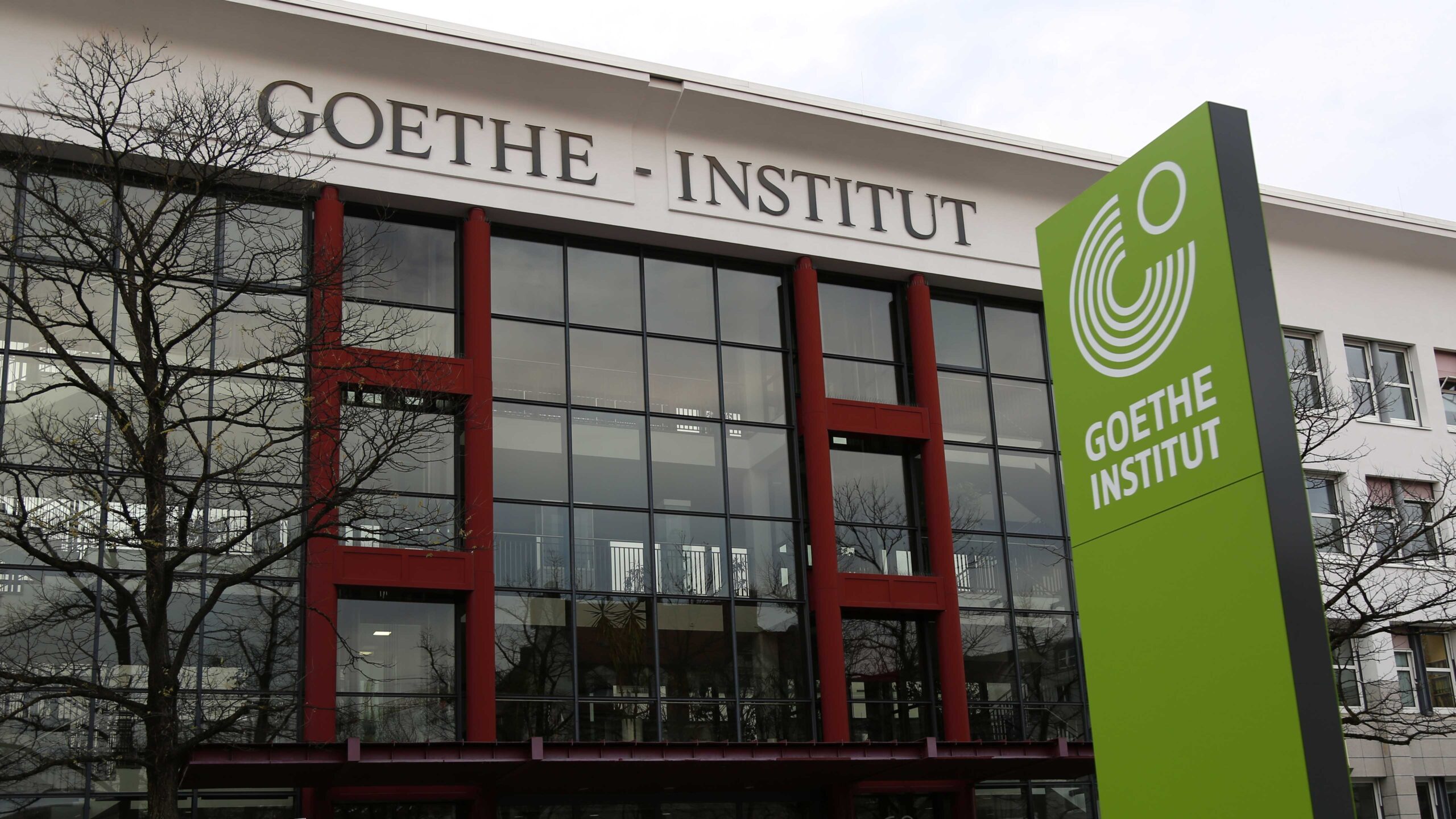 Post image for the Goethe Institut featuring a photo of the outside of the Goethe Insitut building with the name of the organization displayed on the outside and a sign with the organization's green logo outside of it.